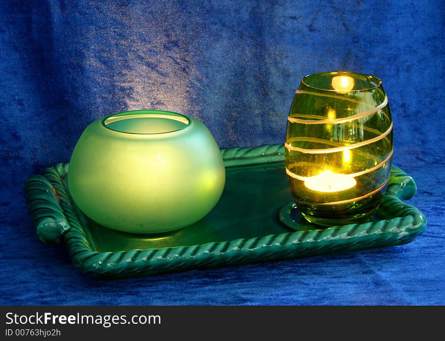 Green plate, cups and candles. Green plate, cups and candles