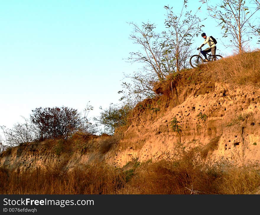 Mountain biker boy on downhill race in forest