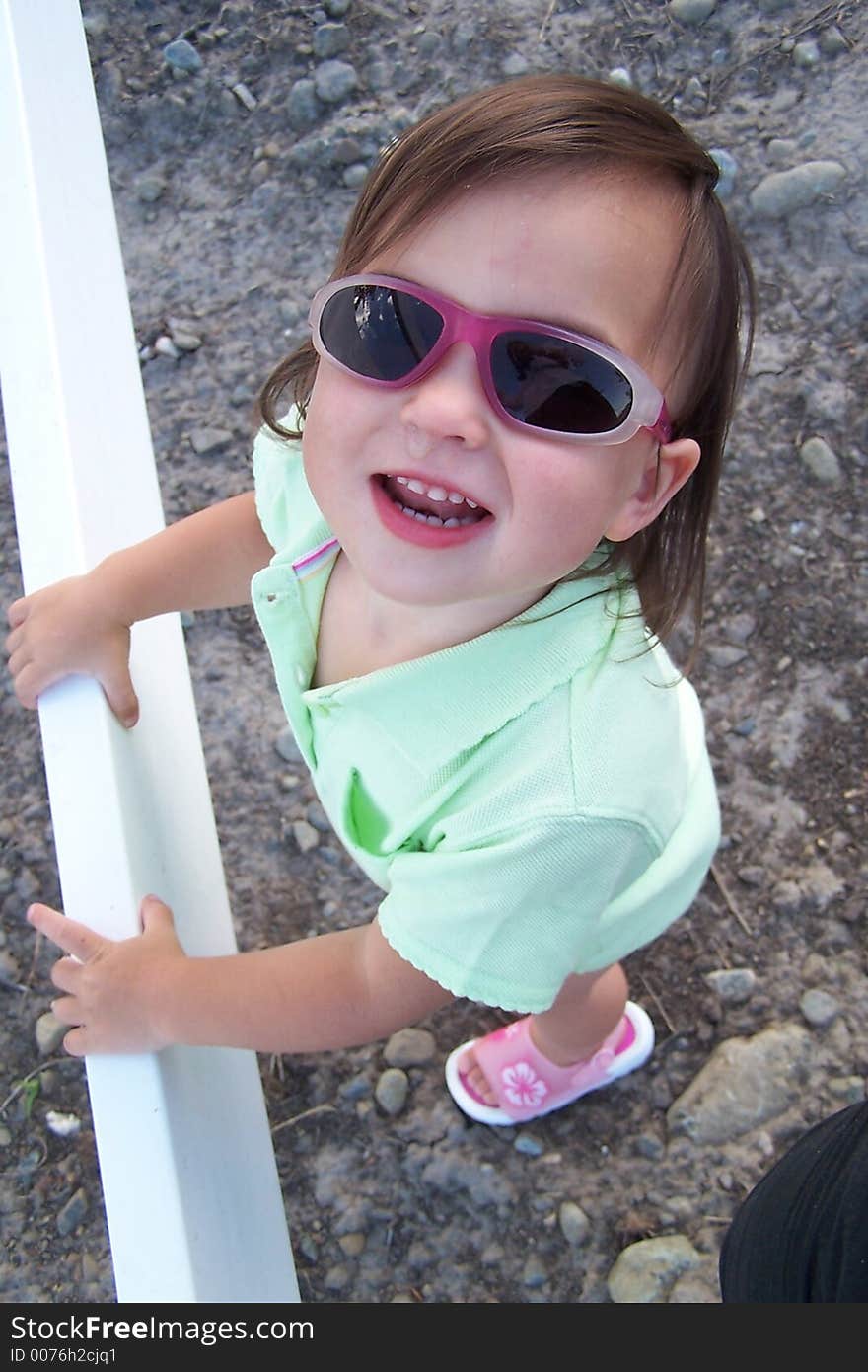 Little girl smiling with sunglasses. Little girl smiling with sunglasses