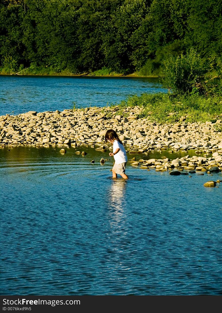 Little girl playing in the river. Little girl playing in the river