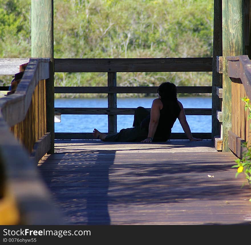 Lady resting from a long walk and enjoying the view at Sawgrass Lake Park in St. Petersburg Florida. Lady resting from a long walk and enjoying the view at Sawgrass Lake Park in St. Petersburg Florida