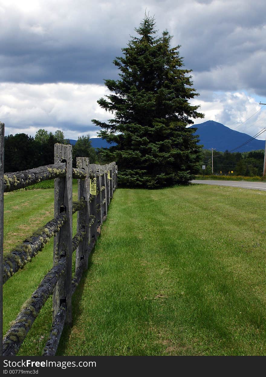 Wooden fence in Adirondack state Park, NY. View on high pekas region. Wooden fence in Adirondack state Park, NY. View on high pekas region