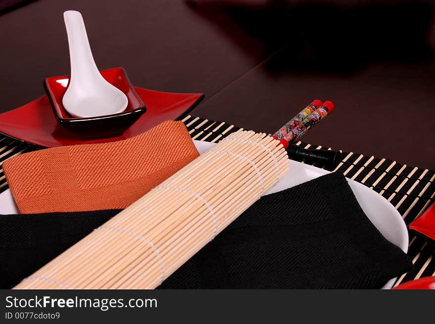 Asian place setting with white and red plates. Asian place setting with white and red plates