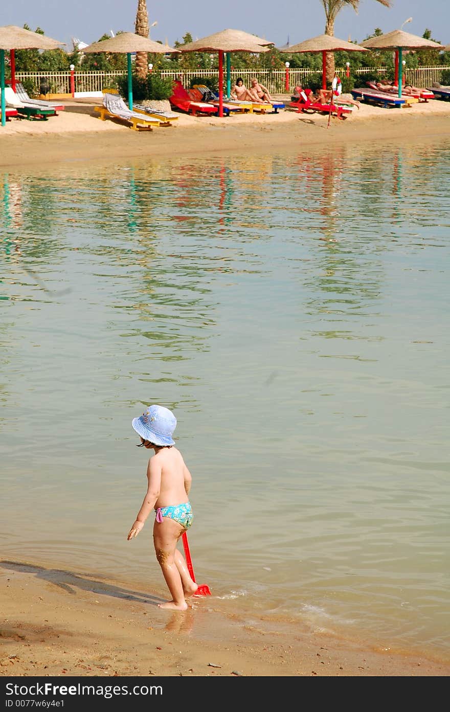 Child strolling with spade