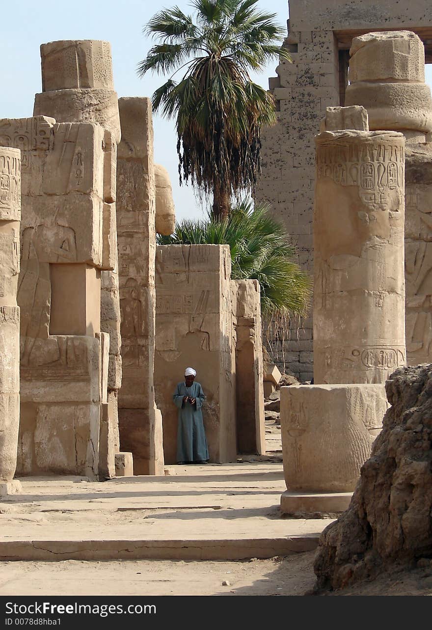 Local man standing against the wall at Luxor