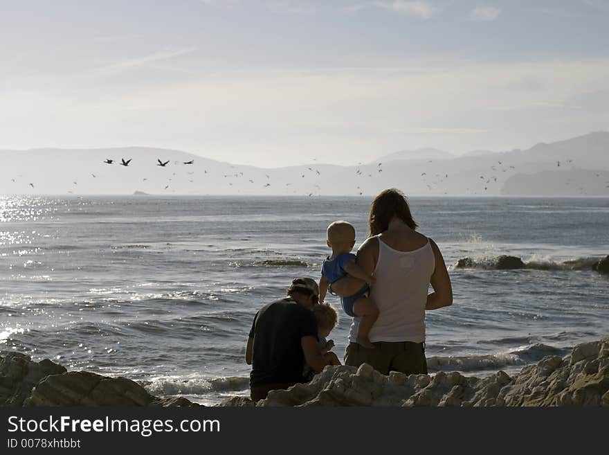 Young couple and their kid at the beach. Young couple and their kid at the beach.