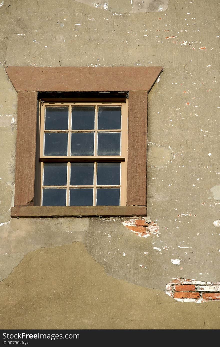 Old framed lighthouse window with exposed brick showing. Old framed lighthouse window with exposed brick showing