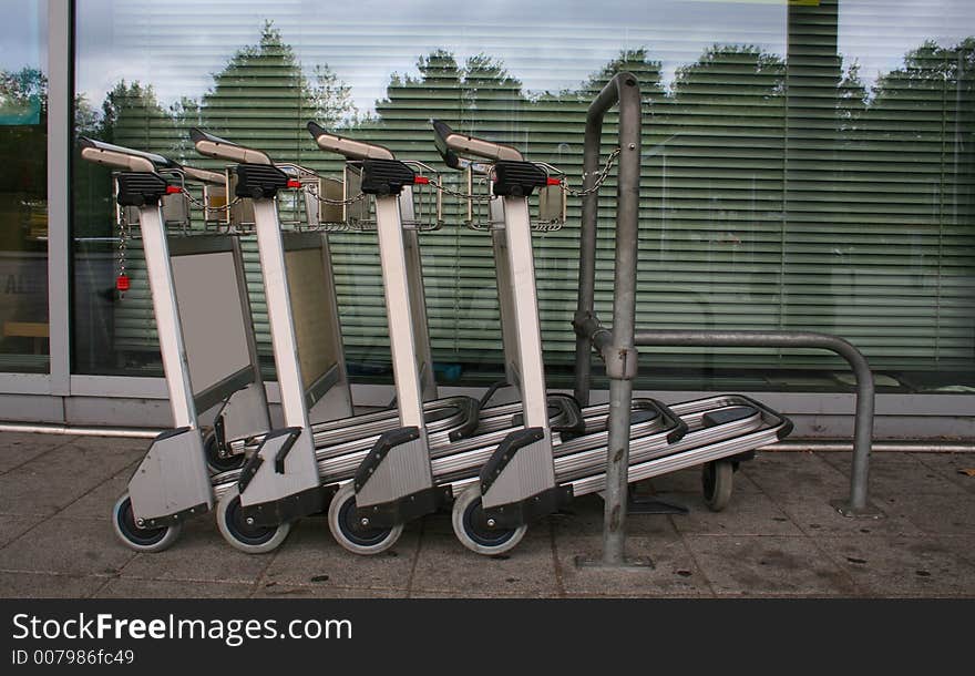 Chained trolleys in line at airport