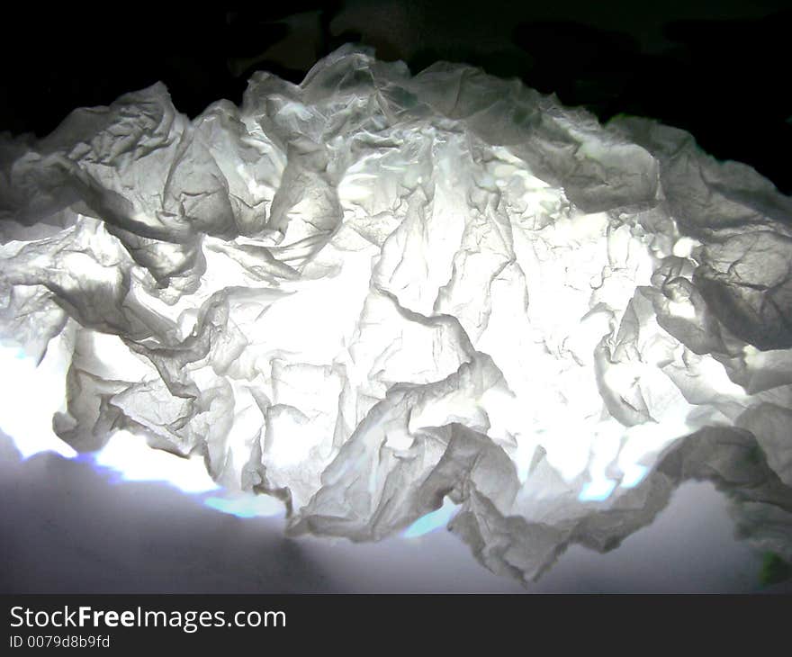 White light passing through wrinkled white paper. White light passing through wrinkled white paper