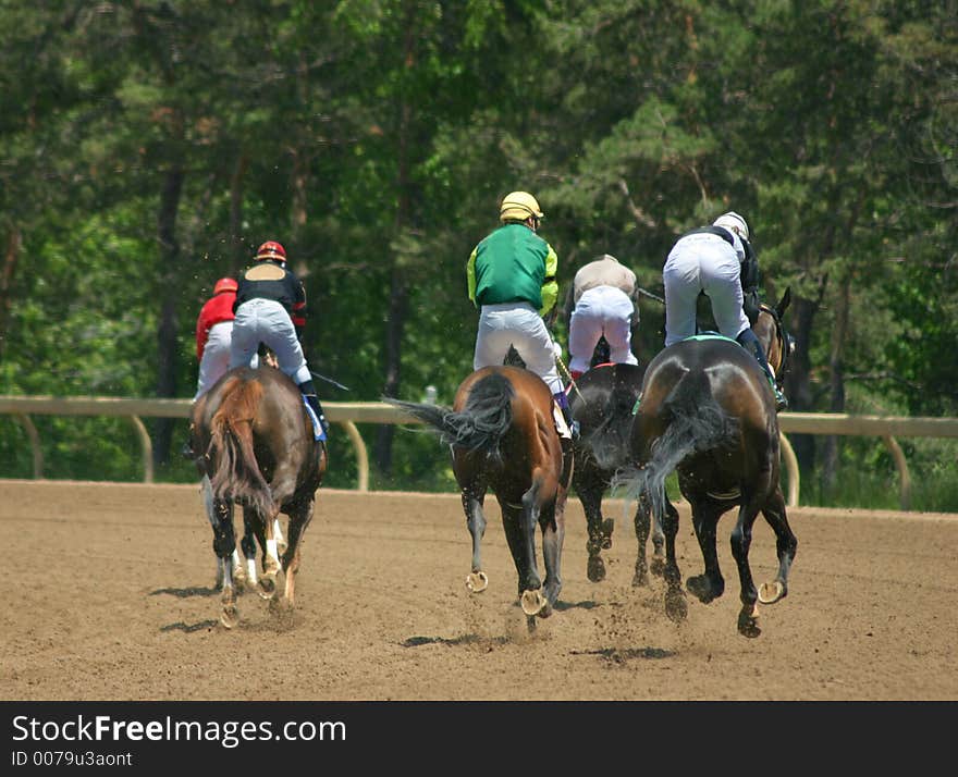 Horses and riders slowing down after the race. Horses and riders slowing down after the race