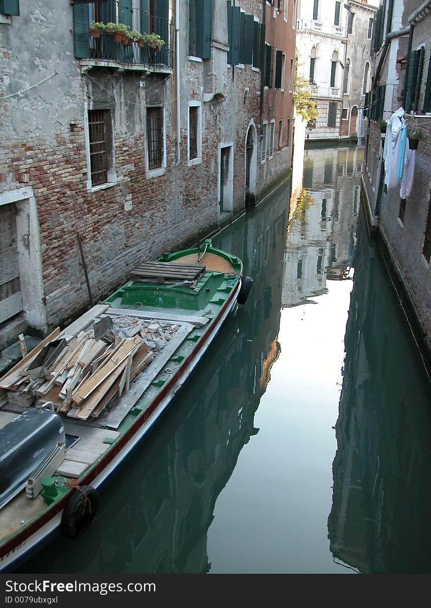 Back alley in Venice  water street with boat and laundry hanging to dry. Back alley in Venice  water street with boat and laundry hanging to dry.