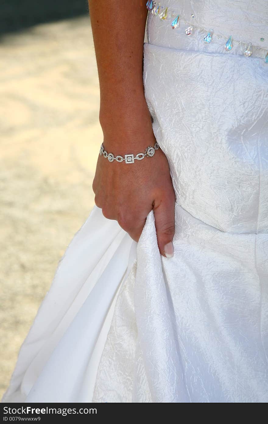 Hand of bride holding her dress. Hand of bride holding her dress