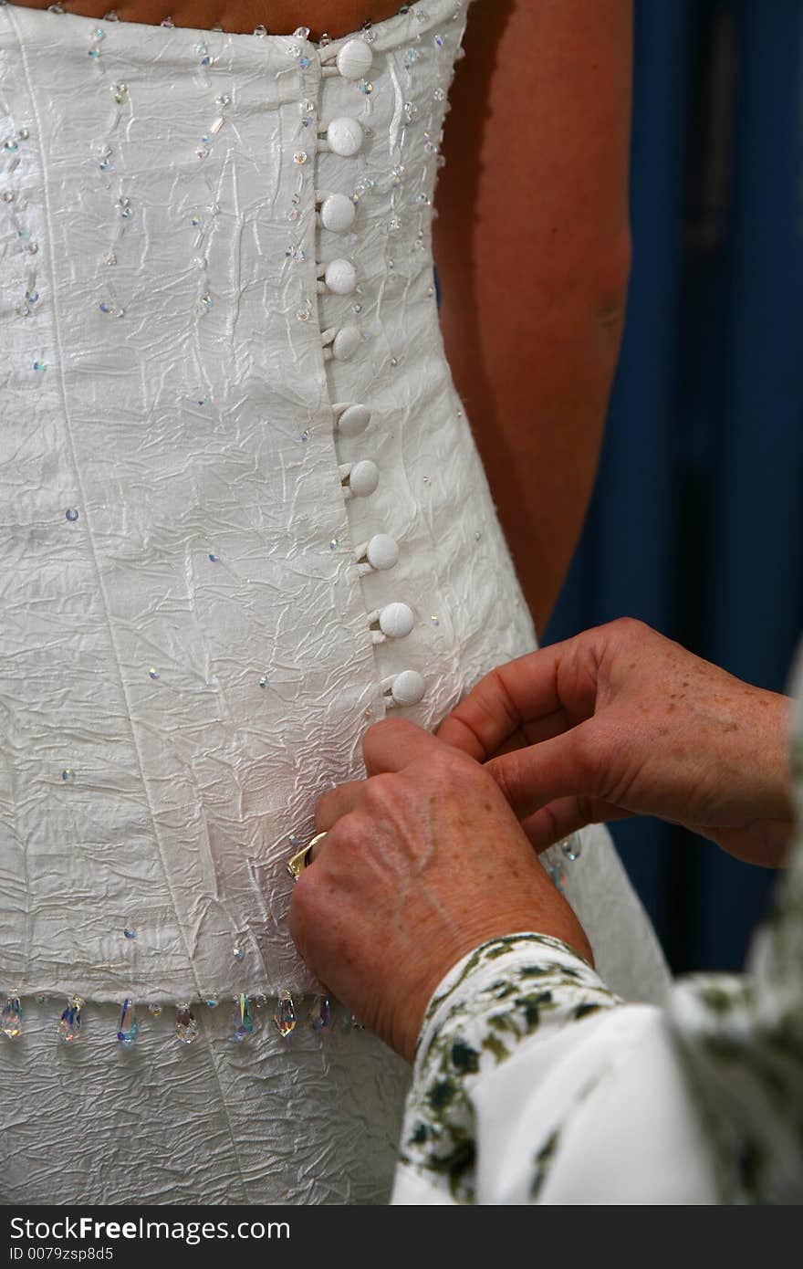 Bride getting dressed on her wedding day