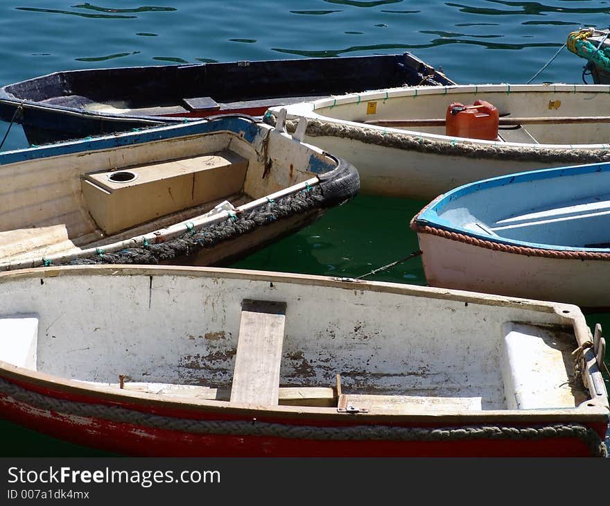 Group of fishing boats moored together in harbor. Group of fishing boats moored together in harbor