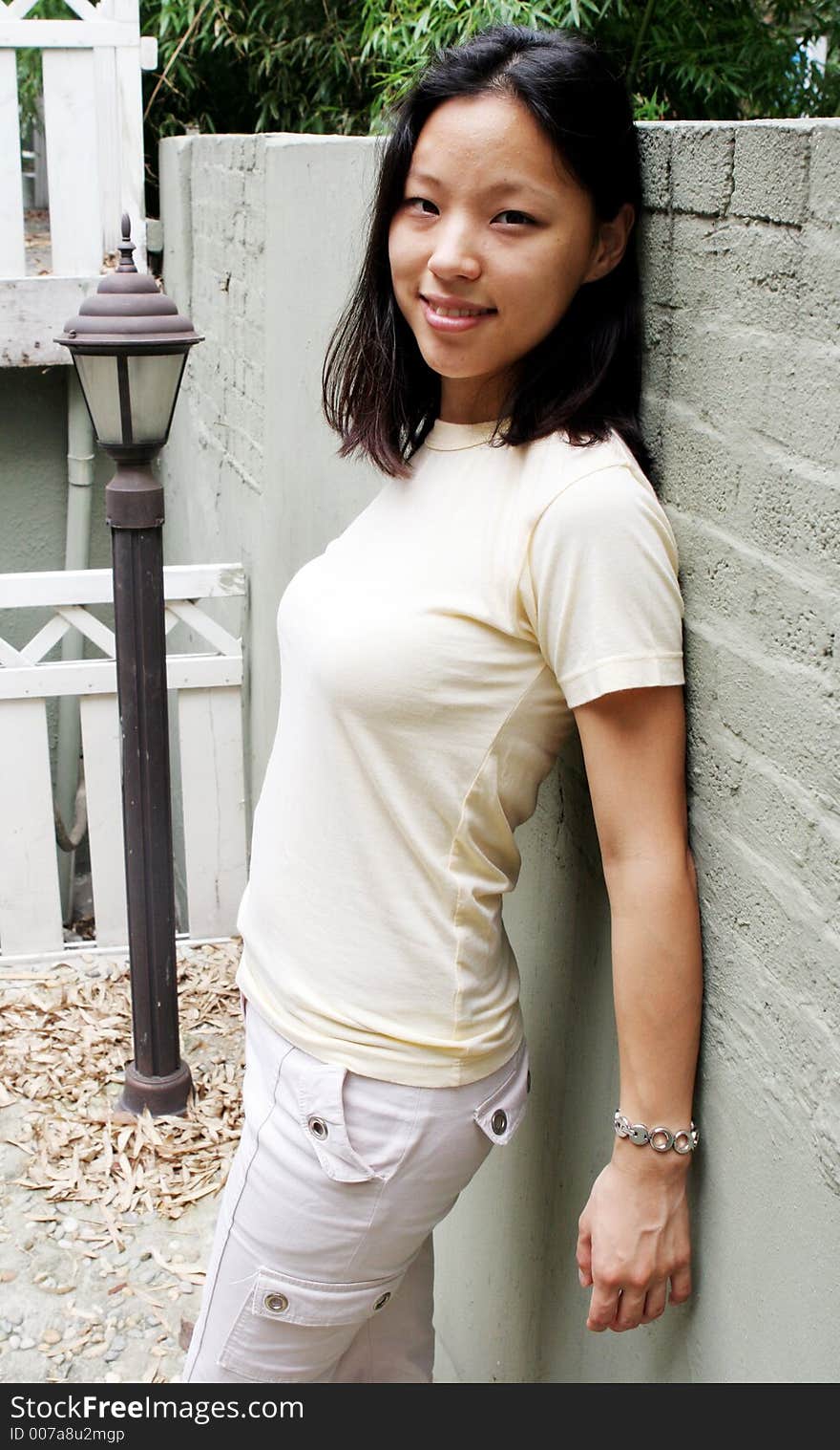 Pretty Korean woman leaning on a wall