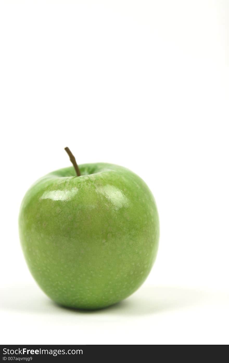 Apple against white isolated with copy space, tall. Apple against white isolated with copy space, tall