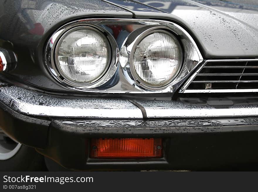 Wet  Vintage car close up view. Wet  Vintage car close up view