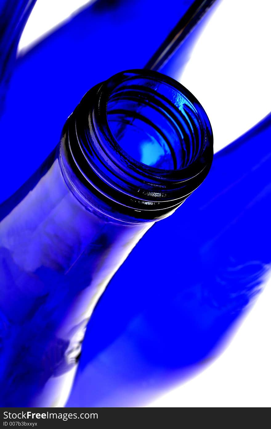 Cobalt blue bottle with reflection in mirrors.