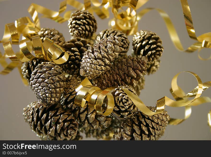 Decorations for Christmas, ribbon and gold sprayed pinecones