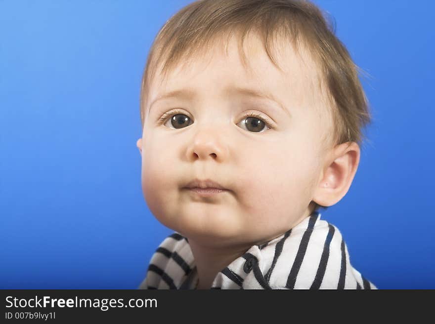 Baby face close up on bllue background