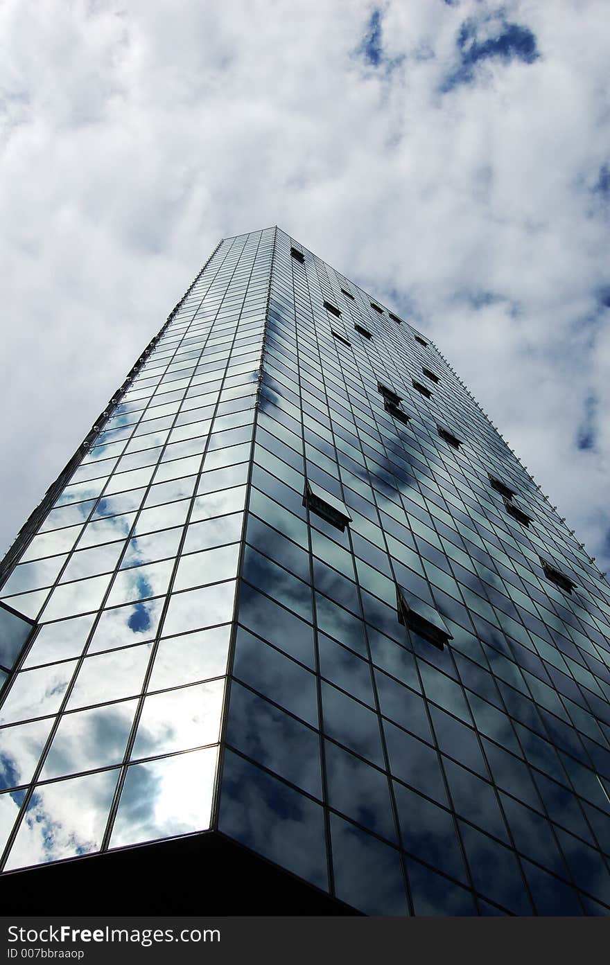 An office tower and cloudy sky