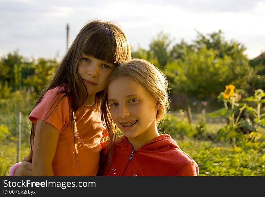 Girls on sunset in garden