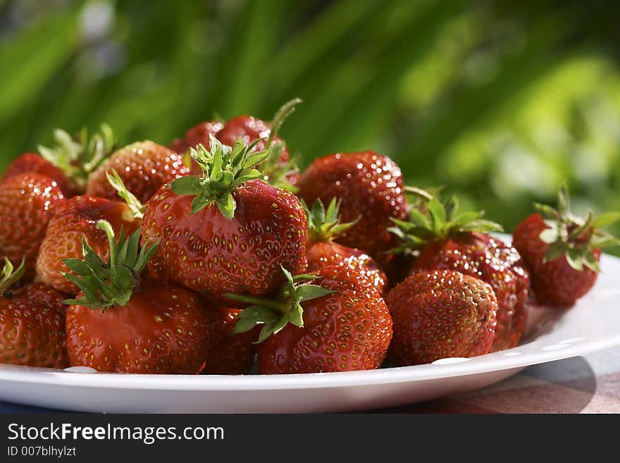 Strawberries on the white plate. Strawberries on the white plate