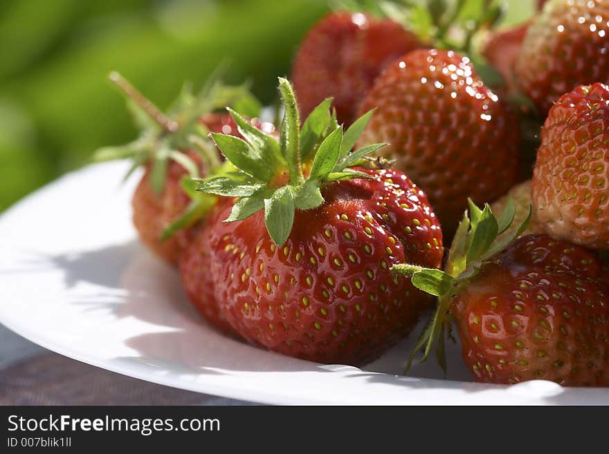 Strawberries on the white plate. Strawberries on the white plate