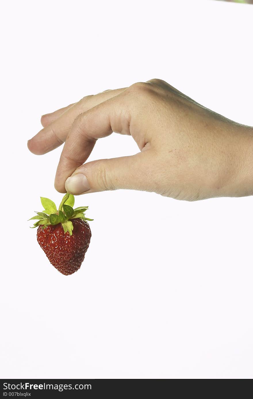 Hand holds the strawberries. Hand holds the strawberries