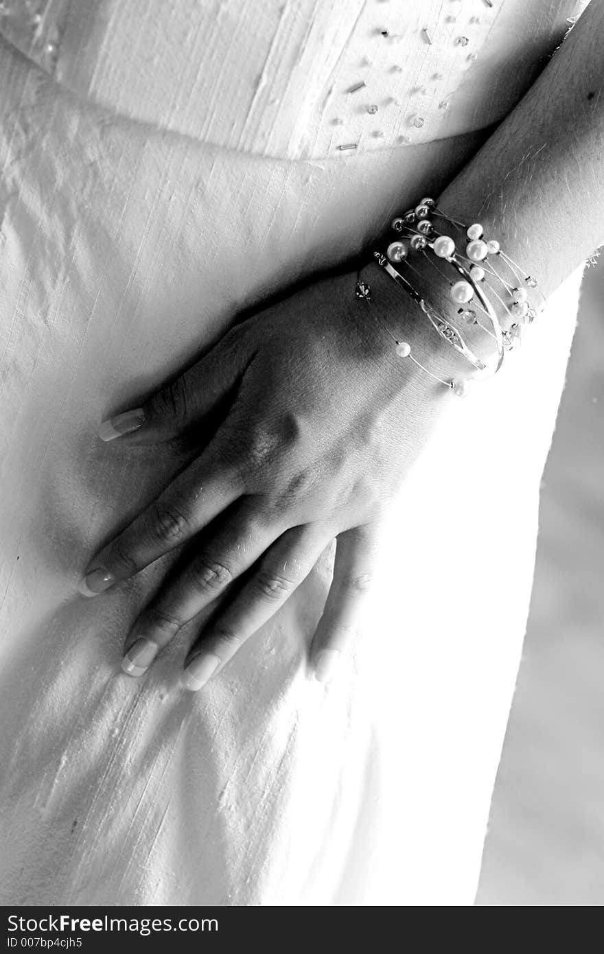 Brides hand on her dress. Brides hand on her dress