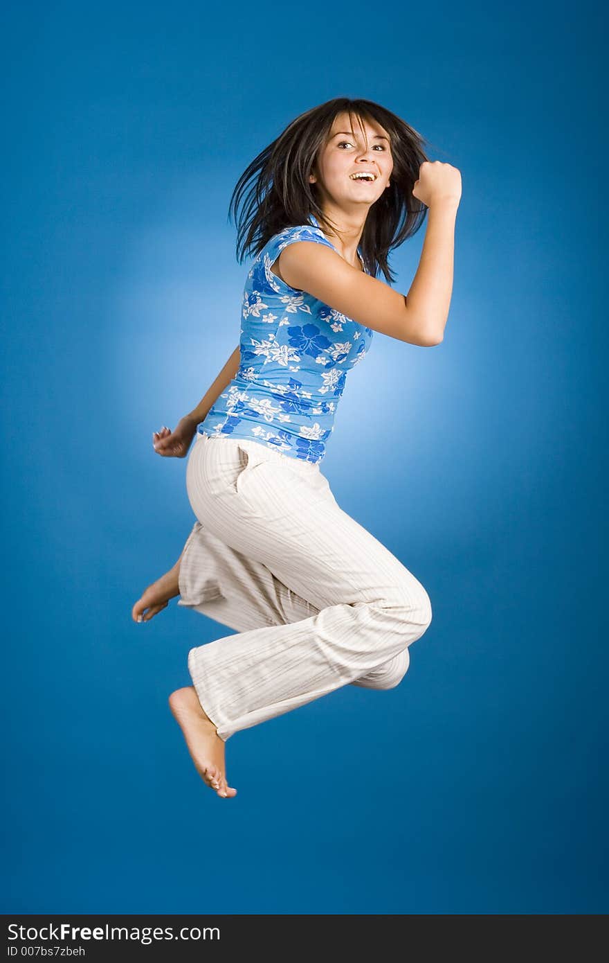 Jumping happy woman on the blue background