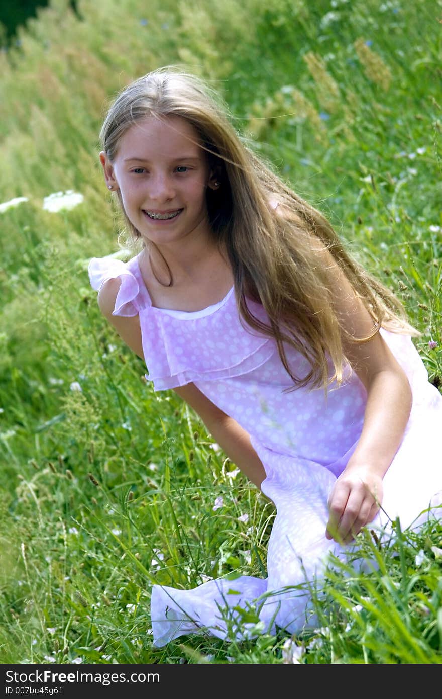 Smiling girl siting on grass