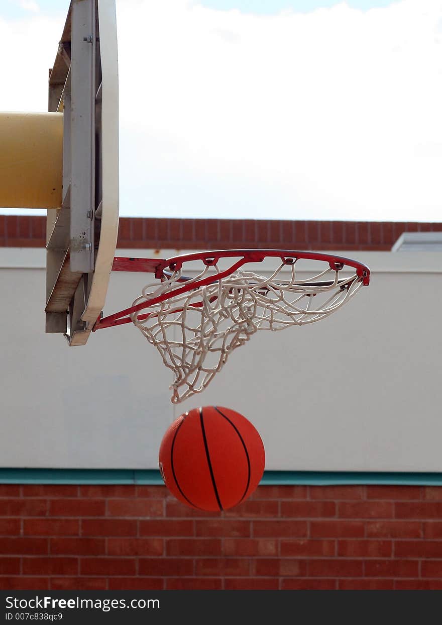 A basketball swishing through the net. A basketball swishing through the net.