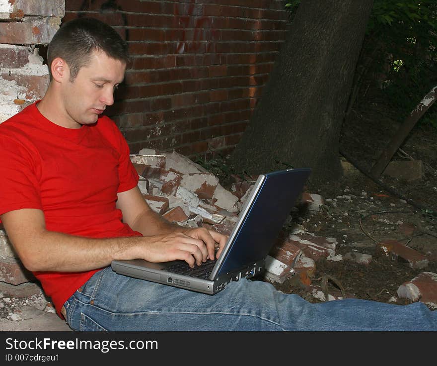 Twenty-six year old man working on laptop. Twenty-six year old man working on laptop.