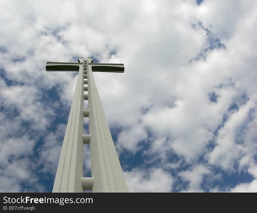 White cross against clouded sky. White cross against clouded sky