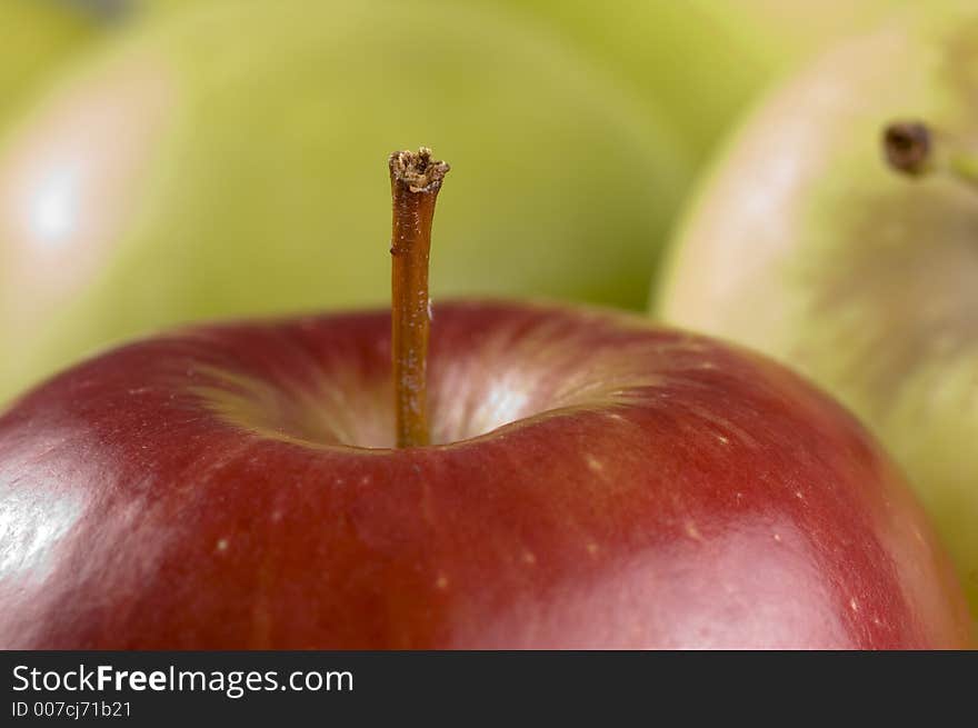 Red apple close up with background of green apples. Red apple close up with background of green apples