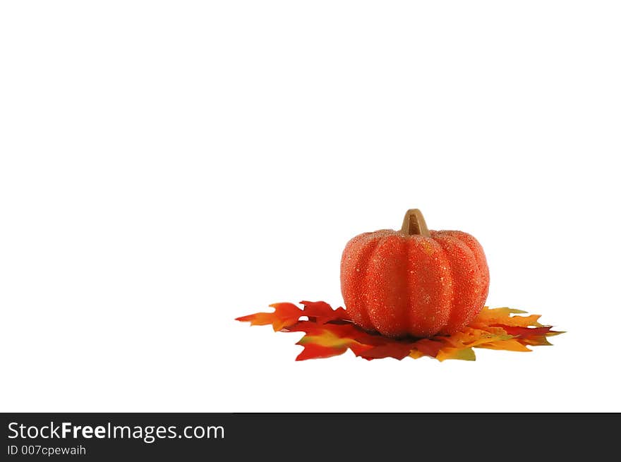 Miniature bright beaded pumpkin with colorful leafs in a right conner - isolated on white. Miniature bright beaded pumpkin with colorful leafs in a right conner - isolated on white