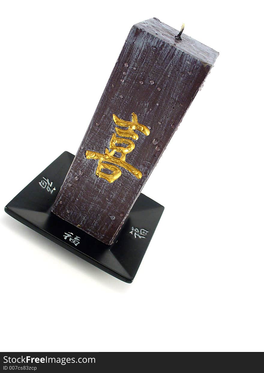 Oriental objects, black candle with golden letters. Oriental objects, black candle with golden letters