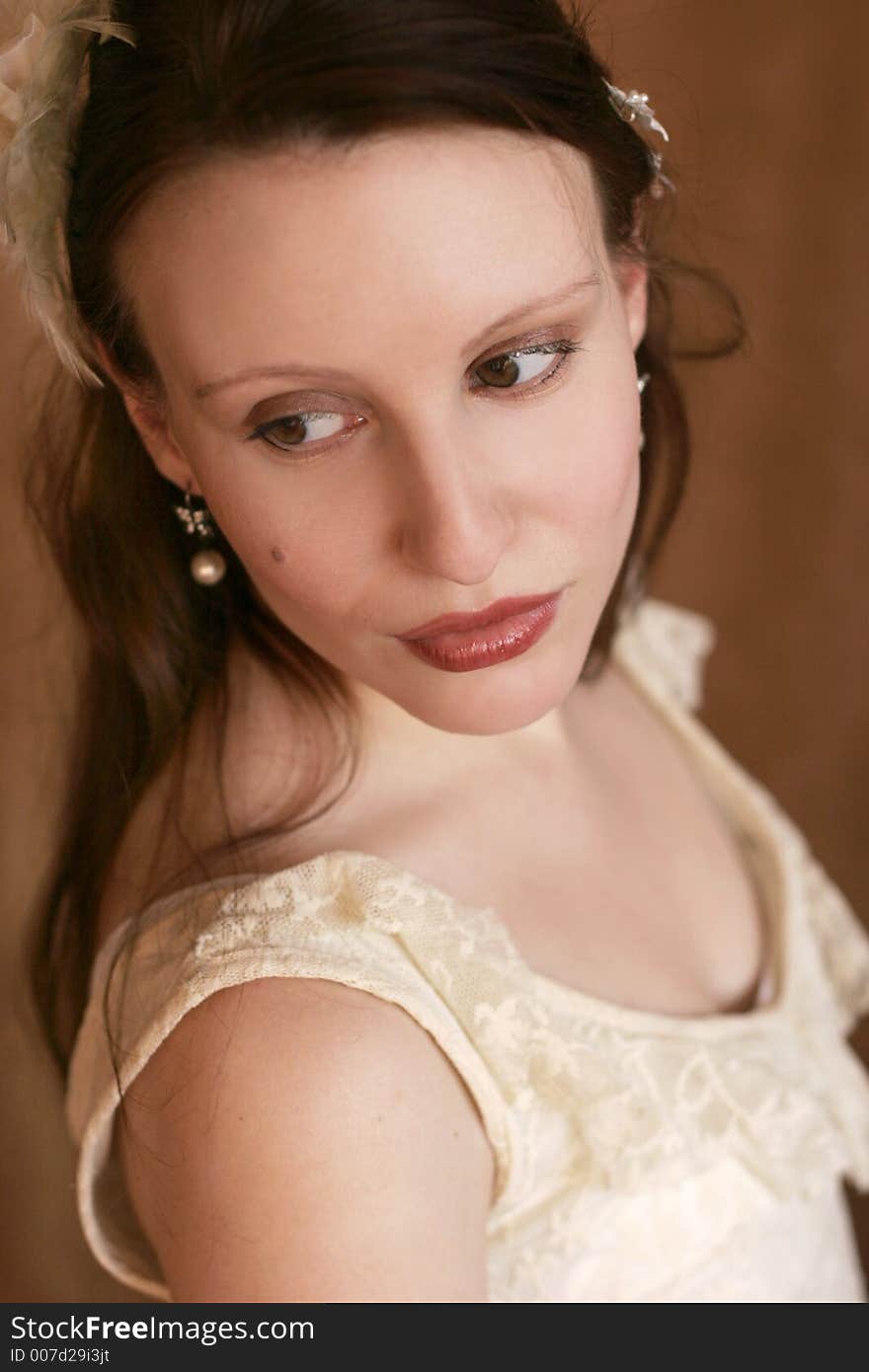 Portrait of a beautiful young woman with feathers in her hair. Portrait of a beautiful young woman with feathers in her hair.