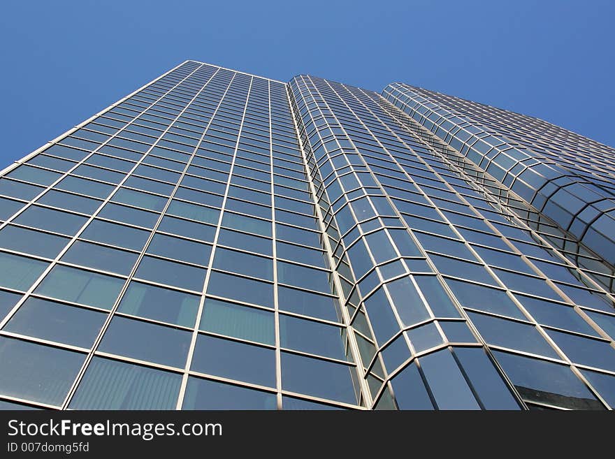 Corporate downtown office building looking up towards a blue sky. Perfect for corporate brochure. Corporate downtown office building looking up towards a blue sky. Perfect for corporate brochure.