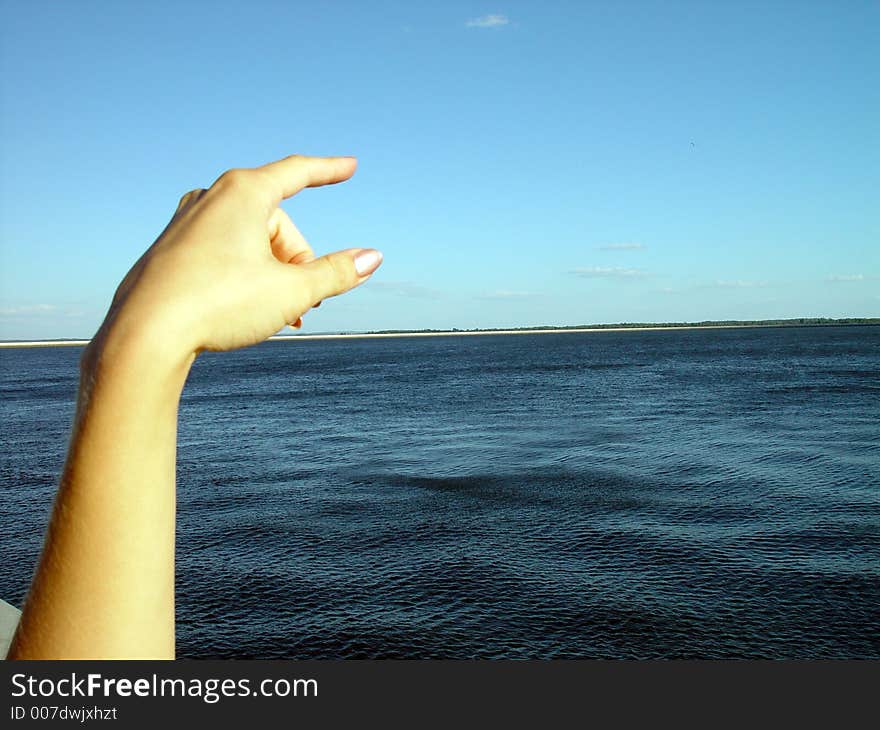 Strong contrast- light finger and blue water. Strong contrast- light finger and blue water