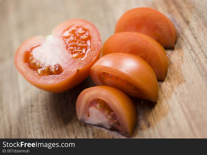 Cut tomato on a wooden surface