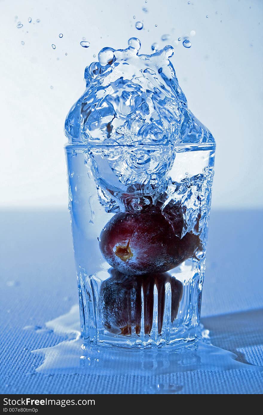 Fruit falling in a glas of water. Fruit falling in a glas of water