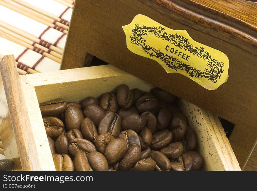 Coffee grinder drawer filled with coffee beans macro