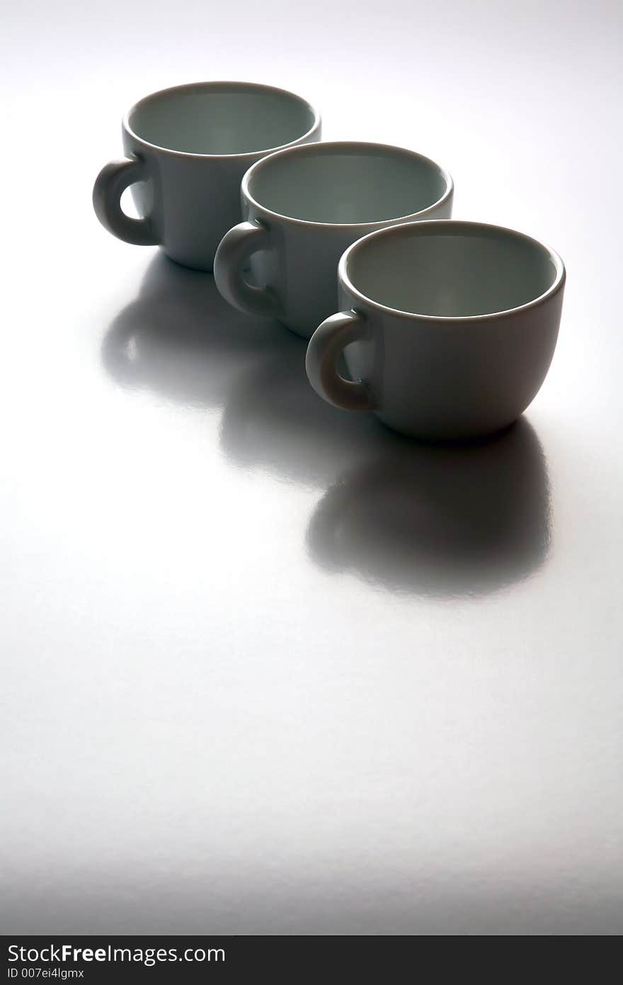 Three white coffee cups on white background