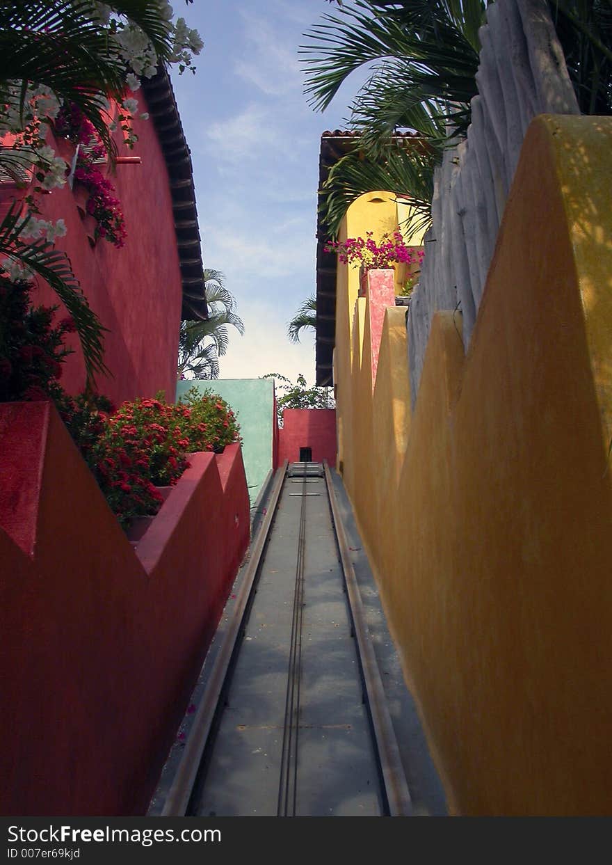 The tram track which runs between colorful buildings in Careyes, Mexico. The tram track which runs between colorful buildings in Careyes, Mexico