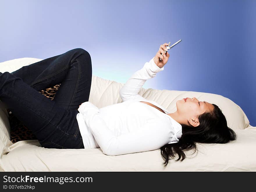 Girl laying down on couch with cell