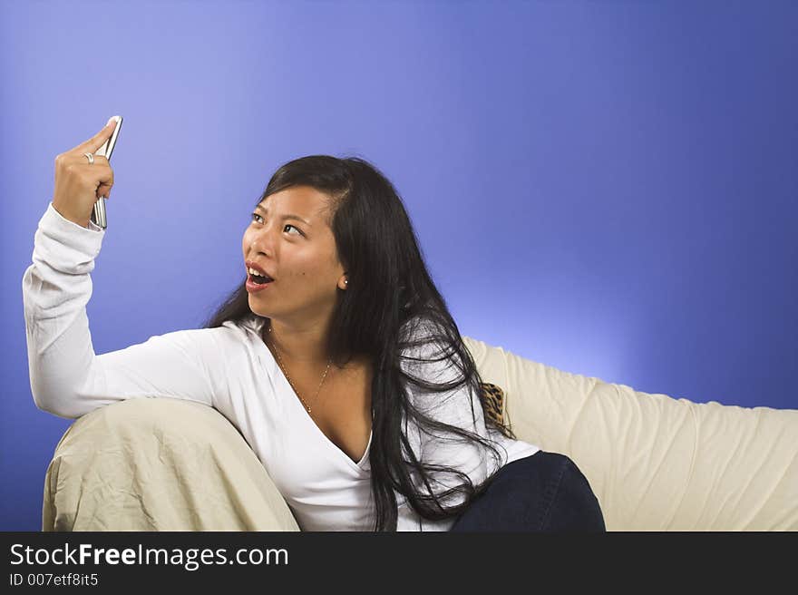 Girl waching cellpone on blue background