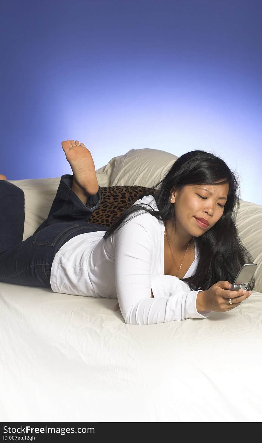 Girl playing with cell phone on couch