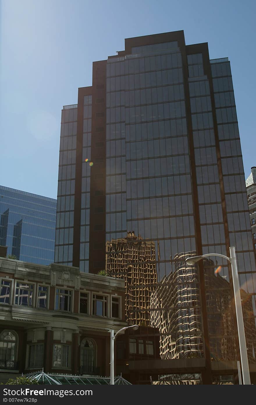 Downtown office building looking up toward the blue sky. Perfect for corporate brochure. Downtown office building looking up toward the blue sky. Perfect for corporate brochure.